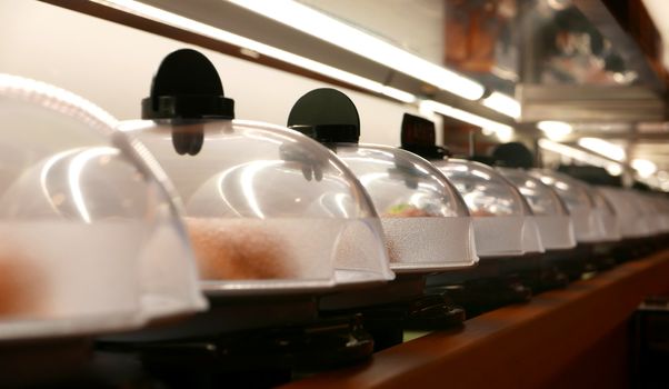 Sushi and sashimi conveyer in Japanese restaurant