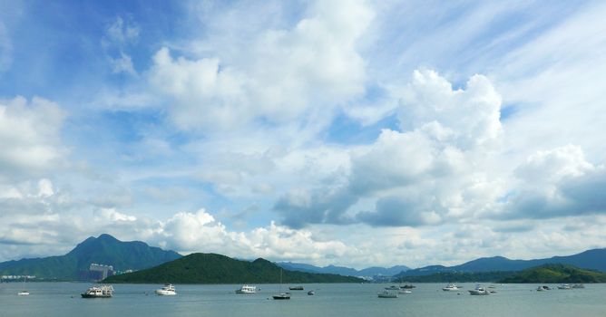 Boats, beautiful clouds, lake and blue sky