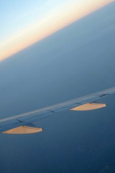 sunset sky and wing from airplane passenger view