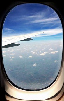 wing and clouds in the sky from airplane window