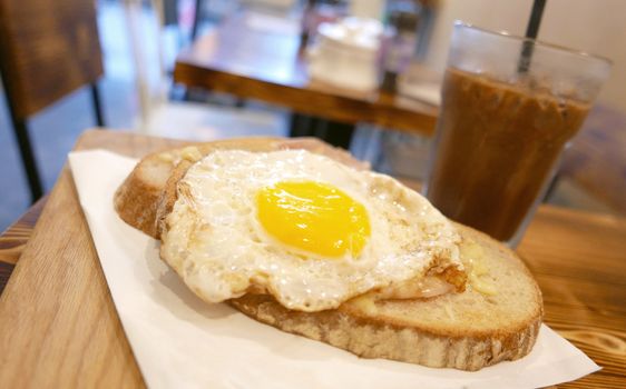 Breakfast sun egg bread with cold drink on the wooden table