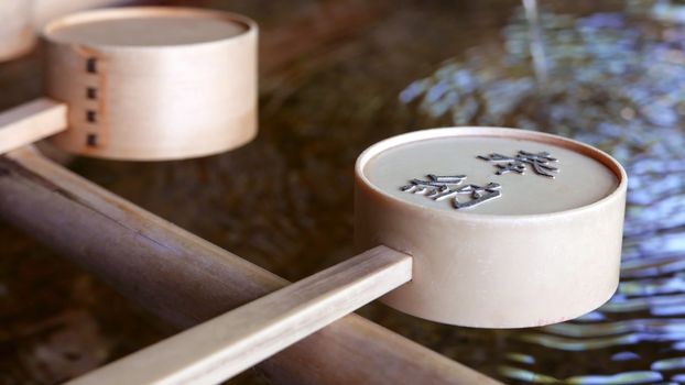 Water flowing from bamboo and spoon in zen garden