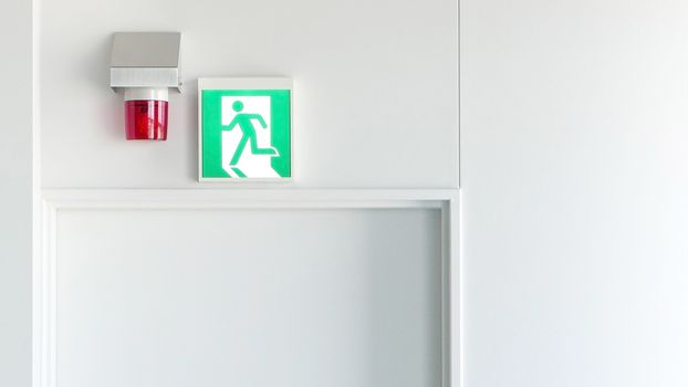 Green emergency exit sign and red alarm light