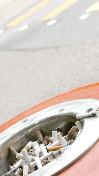 Cigarette butts on recycle bin