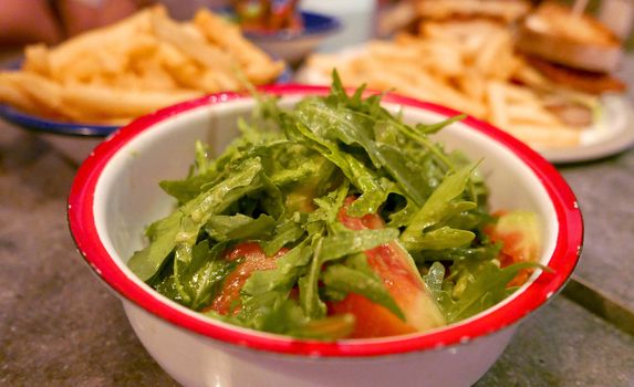 bowl of mizuna salad with some other dishes