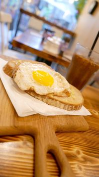 Vertical breakfast sun egg bread with cold drink on the wooden table