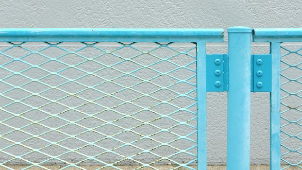 Blue metal chainlink fence in the street