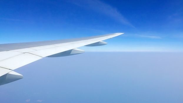 airplane wing and blue sky in the aerial view