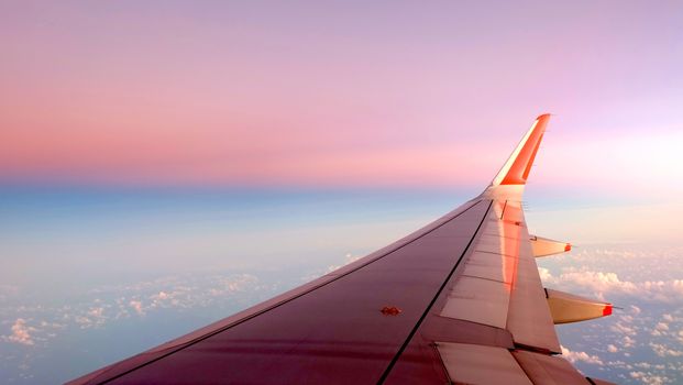 Airplane wing, white cloud and clean blue sky