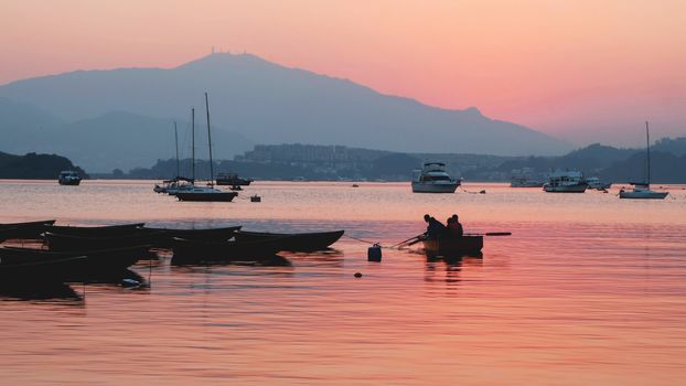 recreational boats on the lake at sunset