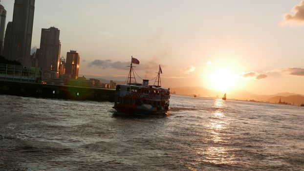 Hong Kong Victoria River, ferry and buildings at sunset