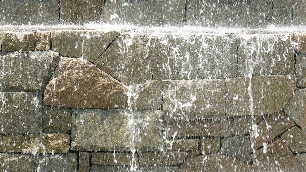 Abstract wet wall waterfall background in sunny day