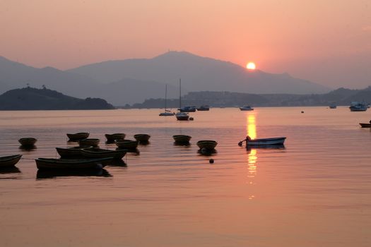 Some shadow of sailboats, fishing and creational boats before sunset