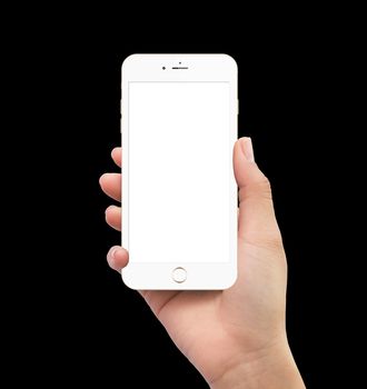 Isolated human right hand holding white mobile smart phone mockup on black background