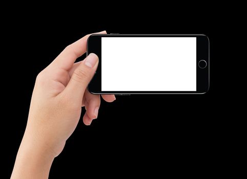 Isolated human left hand holding black mobile smart phone mockup on black background