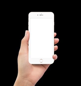 Isolated human left hand holding white mobile smart phone mockup on black background