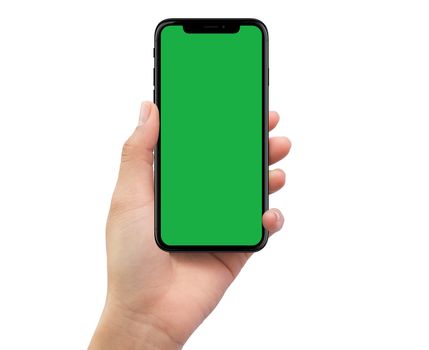 Isolated human left hand holding black mobile smartphone with green screen