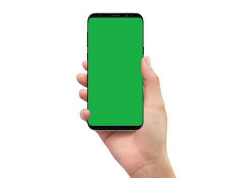 Isolated human right hand holding black mobile smart phone with green screen for video production