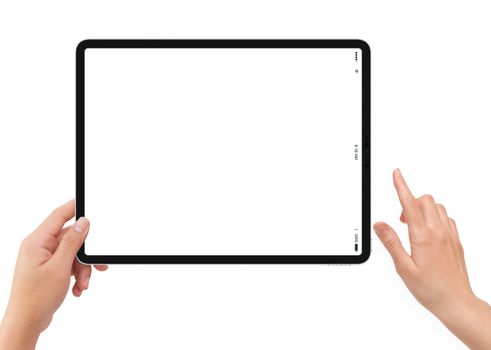 Isolated human left hand holding black tablet media device with white empty screen mockup on white background