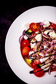 Italian homemade traditional salad with tomato mozzarella onion cucumber