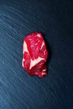 Top view on stone surface with raw steak