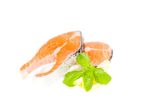 Salmon cuts with basil and lemon isolated on white, copy space