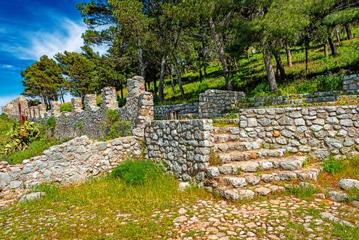 Ruins of ancient castle on the top of Cefalu Rock, large massif in Cefalu city on the shore of Tyrrhenian Sea on Sicily Island in Italy