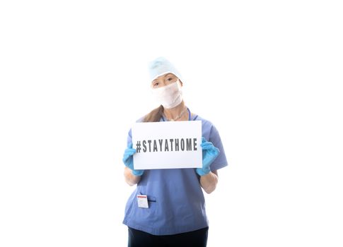 Nurse holding a message to STAY AT HOME during virus pandemic COVID-19, SARS, H1N1 or other infectious outbreak or global pandemic