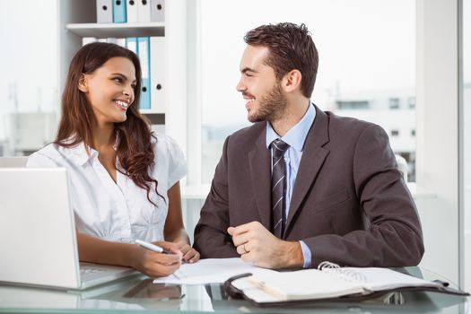 Two young business people in meeting at office