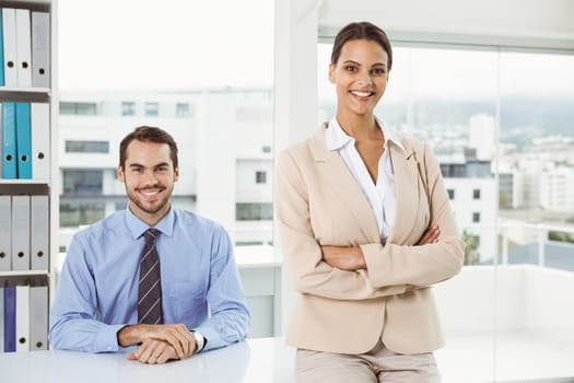 Portrait of two confident young business people in the office