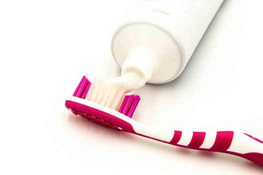 Toothpaste on a toothbrush on a white background