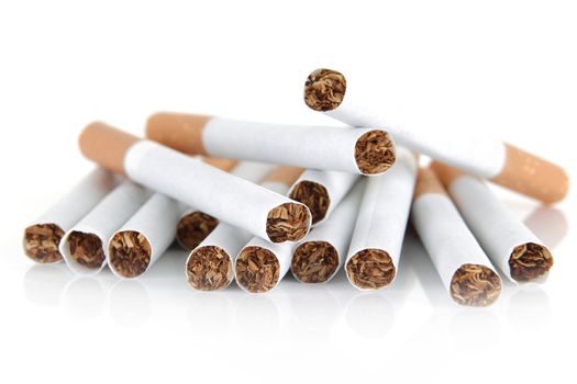 A pile of cigarettes on white background with selective focus