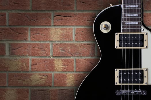 A vintage electric guitar on brick background with copy space