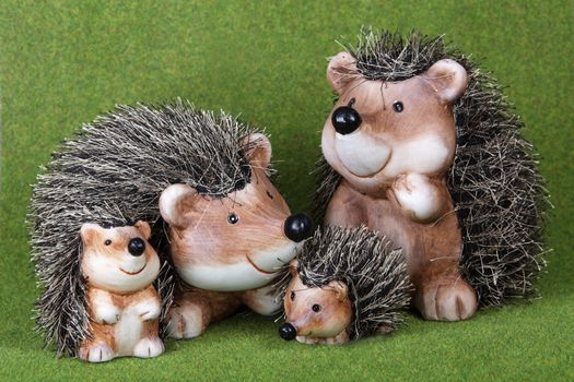 A family of cute toy Hedgehogs together on grass