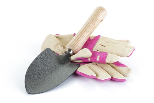 A garden trowel and gloves on a white background