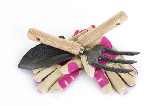A garden fork trowel and gloves on white