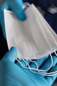 Doctors or Nurses Wearing Surgical Gloves Handing Over Medical Face Masks.