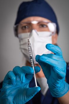 Doctor or Nurse Holding Medical Syringe with Needle.