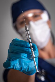 Doctor or Nurse Holding Medical Syringe with Needle.