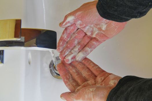 Washing hands with soap under the tap with water. Hand washing with soap and water to prevent coronavirus and hygiene to stop the spread of coronavirus