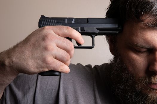mental health issues causing a man to hold a gun to his head.