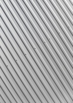 Metal white sheet for industrial building and construction on blue sky background. Roof sheet metal or corrugated roofs of factory building or warehouse