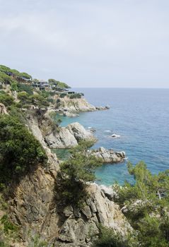 Panorama of Rocks on the coast of Lloret de Mar in a beautiful summer day, Costa Brava, Catalonia, Spain. Waterfront of Lloret de Mar Costa Brava Spain. Rocks on the coast of Lloret de Mar