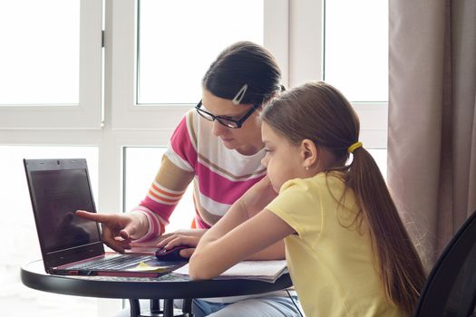 Girl helps girl figure out how to use the Internet