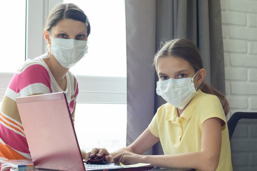 Quarantine mom and daughter do home lessons online