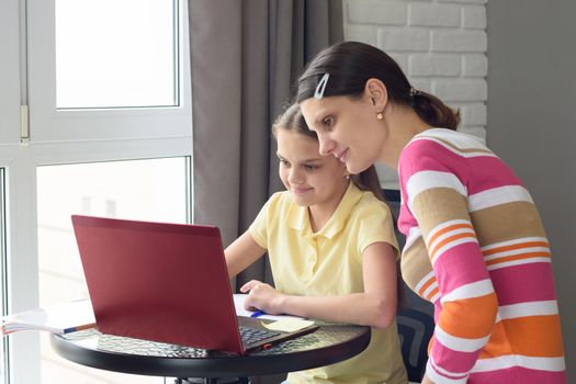 Mom and child do homework together without leaving home