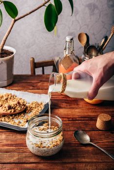 Healthy breakfast with granola, milk and juice