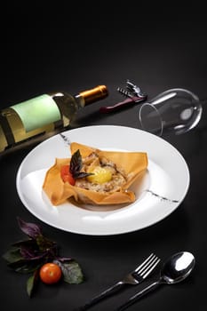 Glass of white wine and dish with pasta