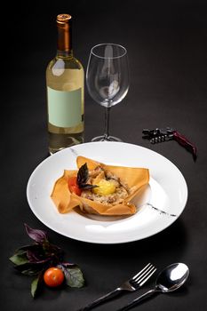 Glass of white wine and dish with pasta