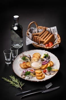 Salted Herring with potatoes, black bread and garlic. Russian appetizer to vodka